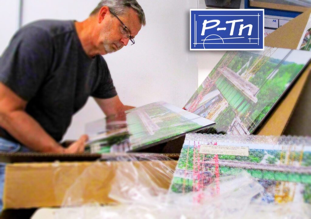 Opening a shipment of professional prints for framing and wall display.