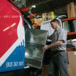 Man loading truck with equipment