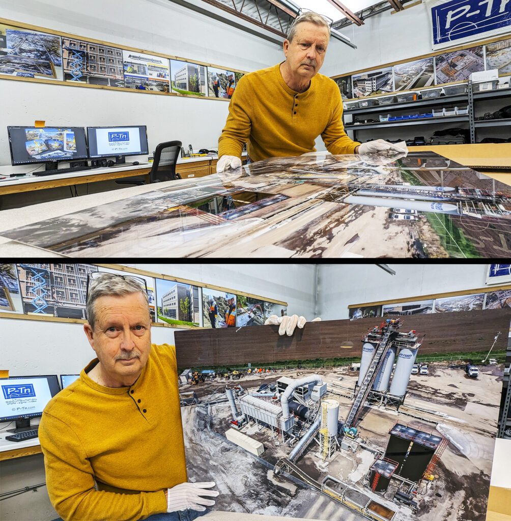 P-Tn professional photographer examines an aerial photo produced on aluminum for construction business wall display.
